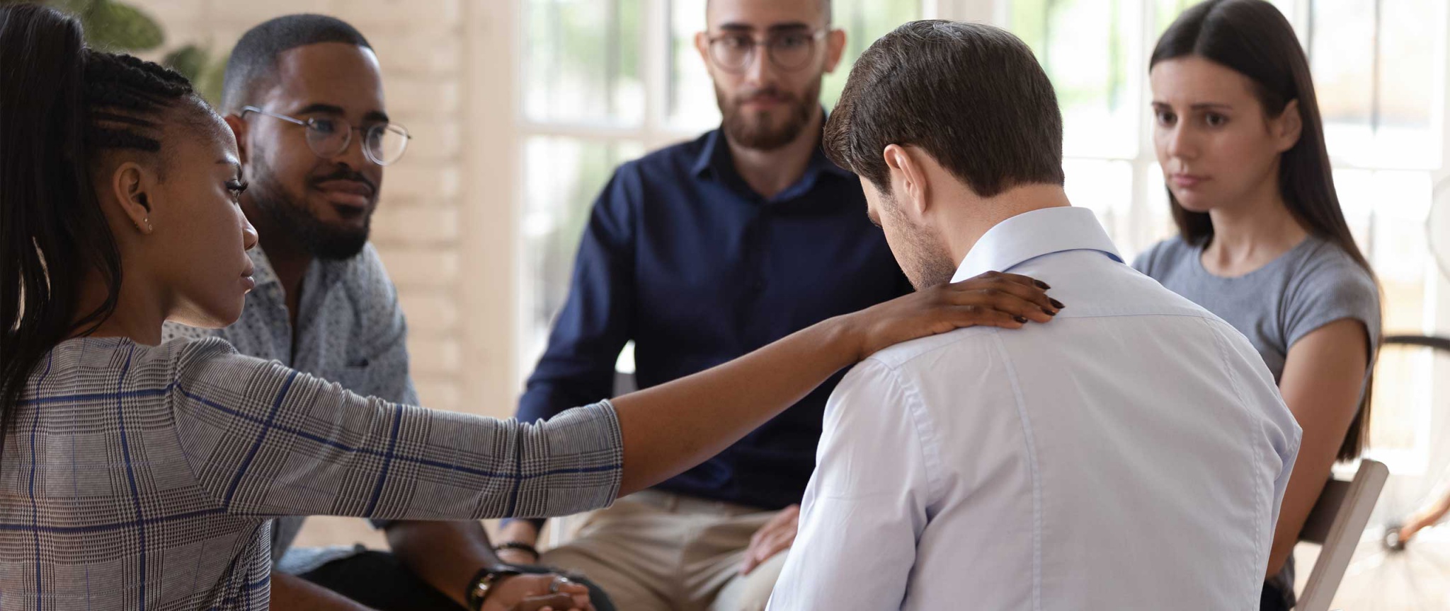 a person touching the shoulder of a man