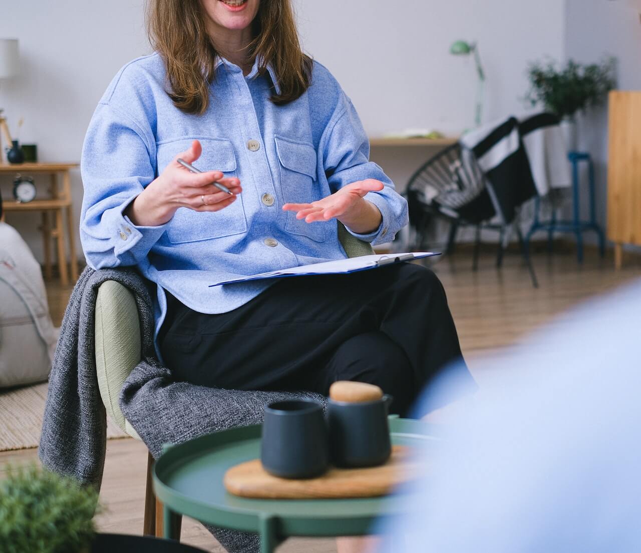 a woman sitting in a chair talking to a man