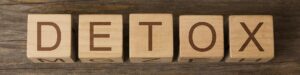 a wooden blocks with letters on them spelling detox