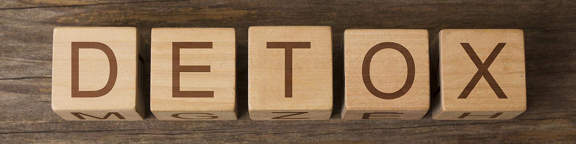 a wooden blocks with letters on them spelling detox