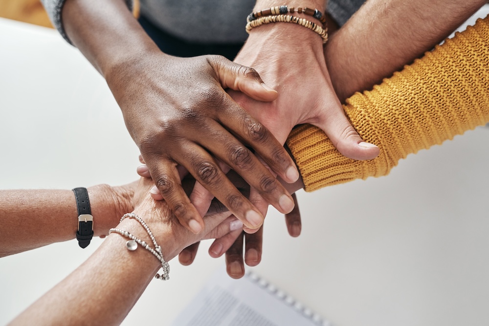 Close up photo of group hands together in a circle