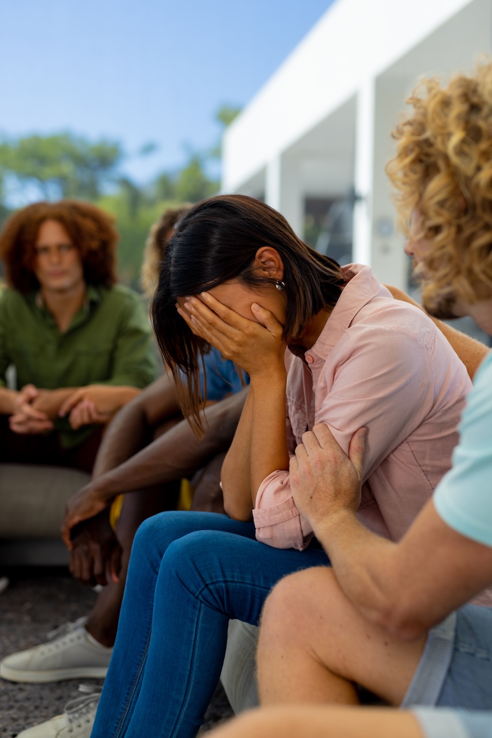 Upset woman in group therapy session