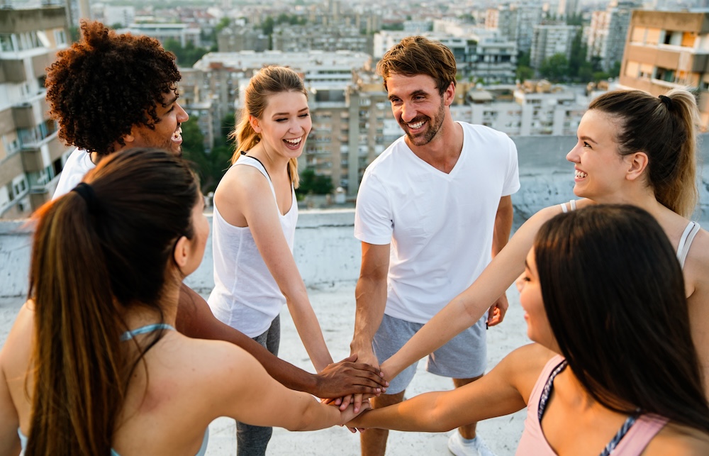 Group of fit healthy friends, people exercising together outdoor