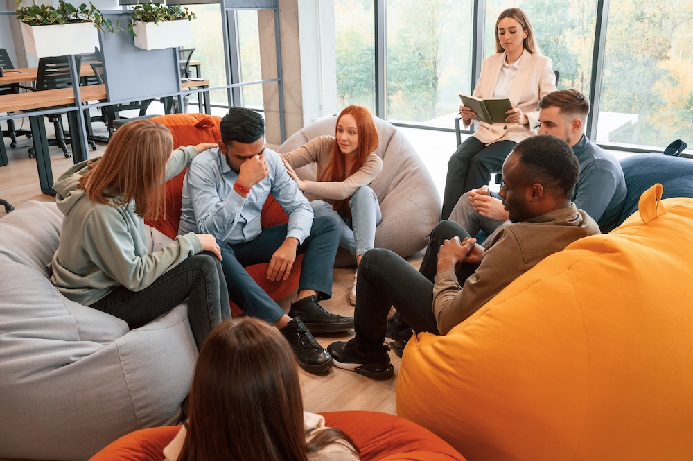 Group of people are having therapy meeting together.