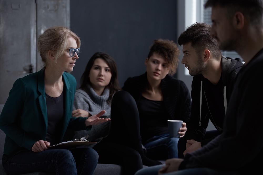 Therapist talking with patients of rehab center