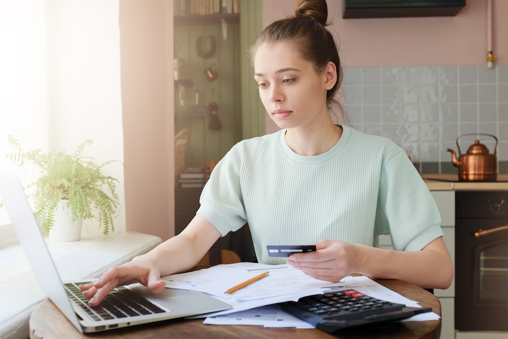 Young woman paying for something online with credit card