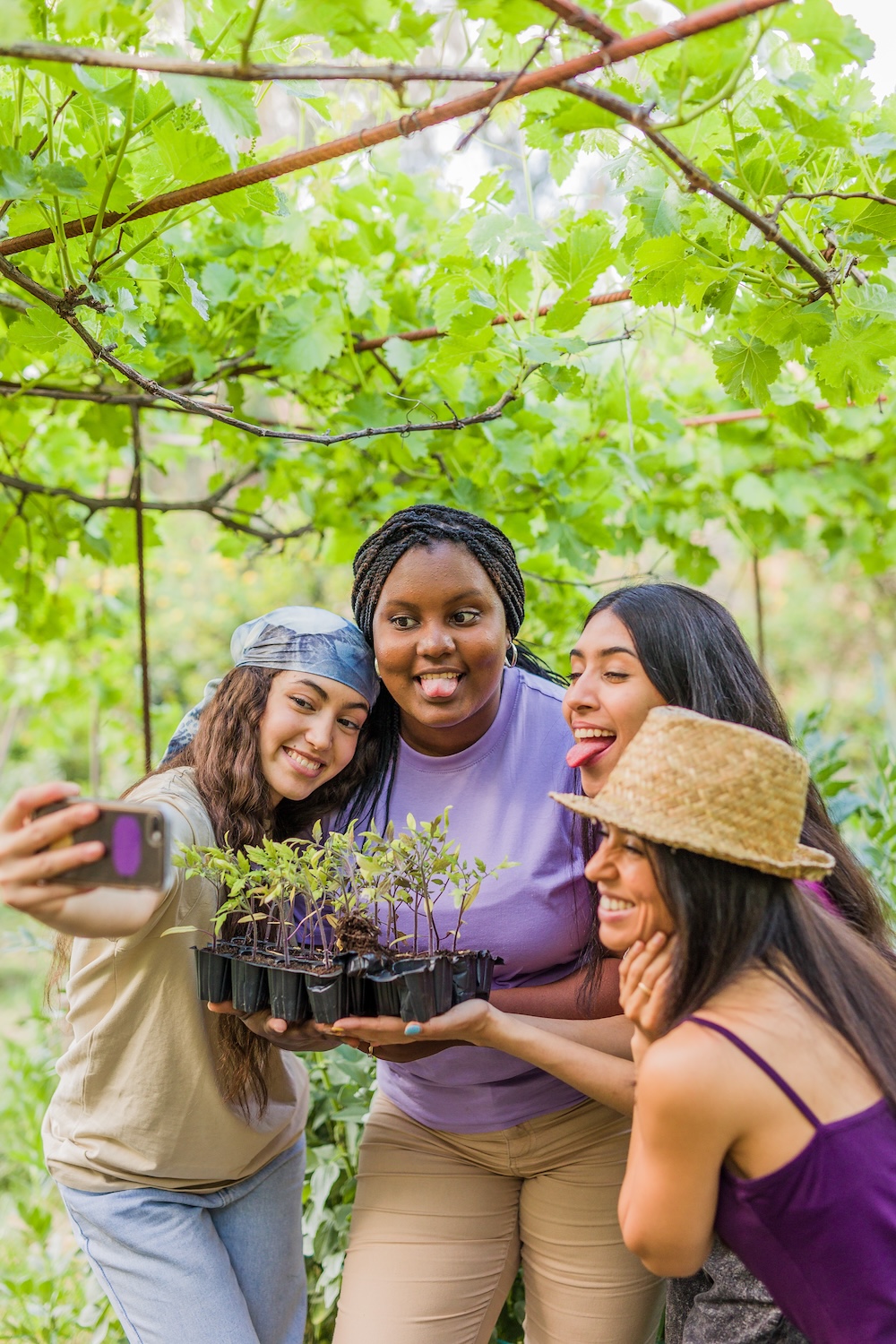 Group of friends taking a selfie while working together outdoors