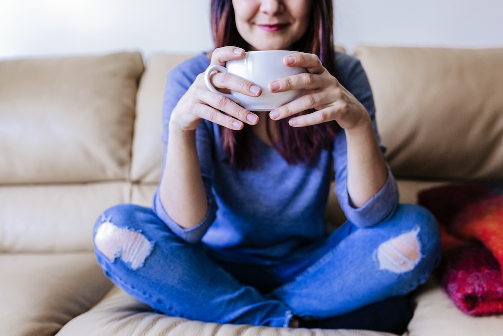 young woman having coffee or tea during therapy session