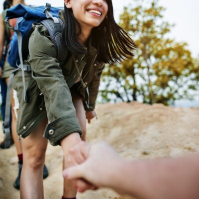 Young woman reaching out her hand to a friend for support.