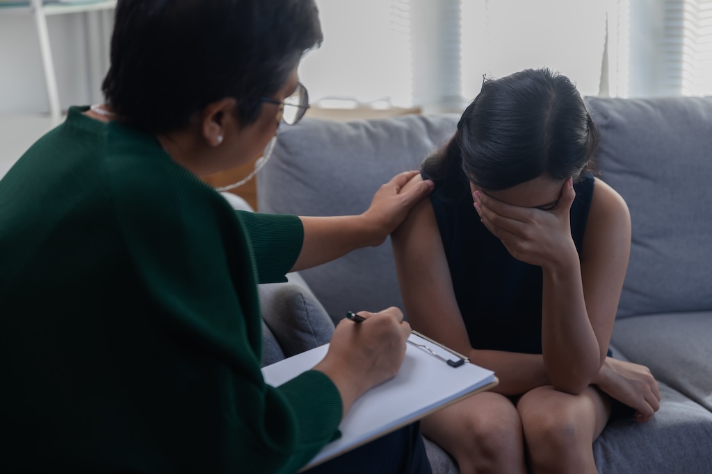 Young woman consulting a psychiatrist about generalized anxiety disorder.