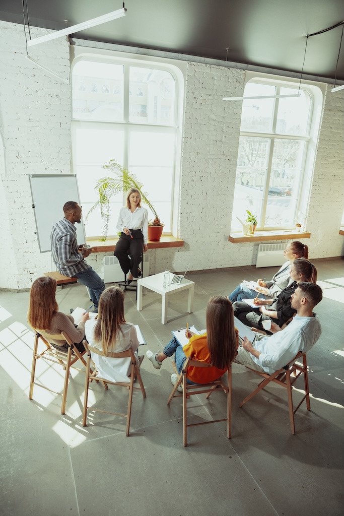 Female speaker giving presentation in clinical outpatient treatment program