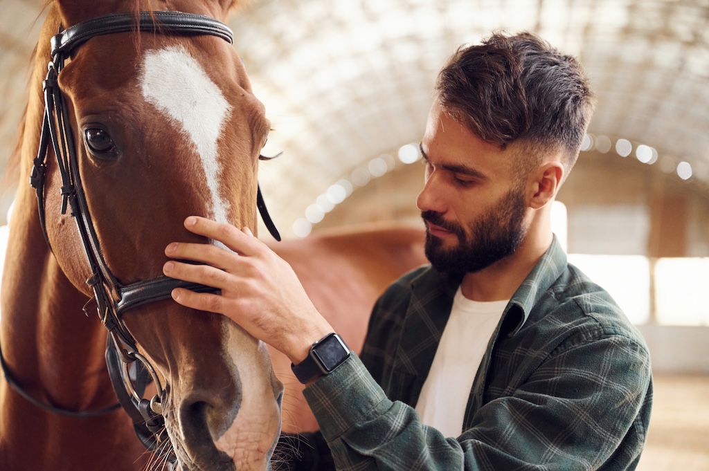 Young man with a horse, healing and emotional connection with animals.