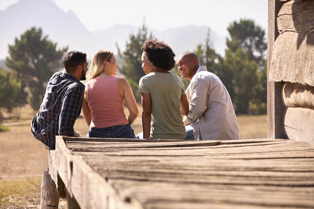 Rear view of group of clients sitting together between treatment programs during residential care.