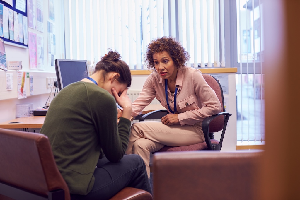 Patient meeting with therapist in office.